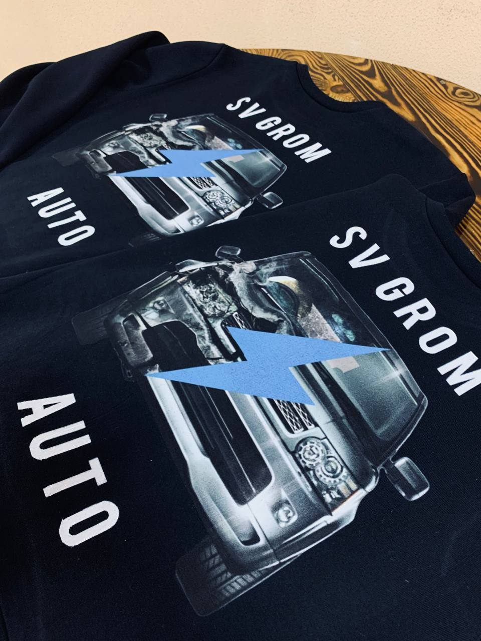 Photo print of a truck on black client tees