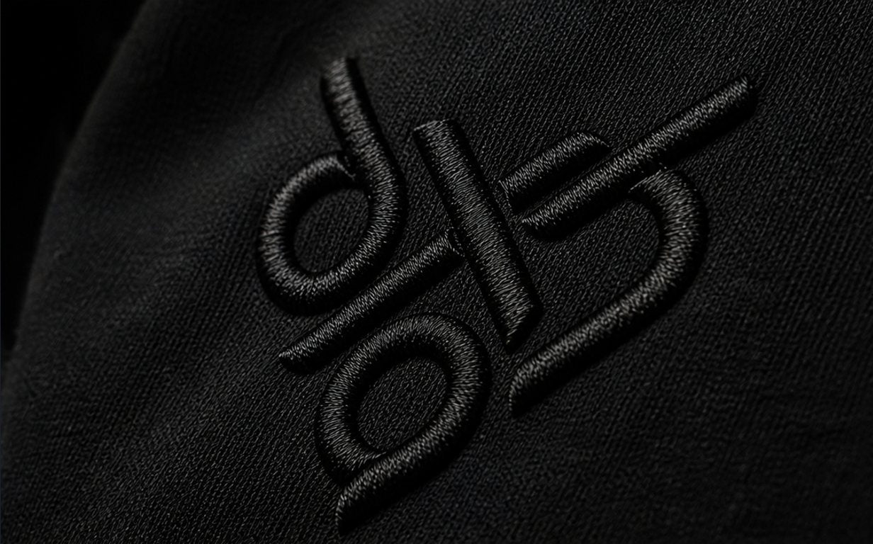 Black-on-black embroidered logo — raised stitching, premium tonal finish