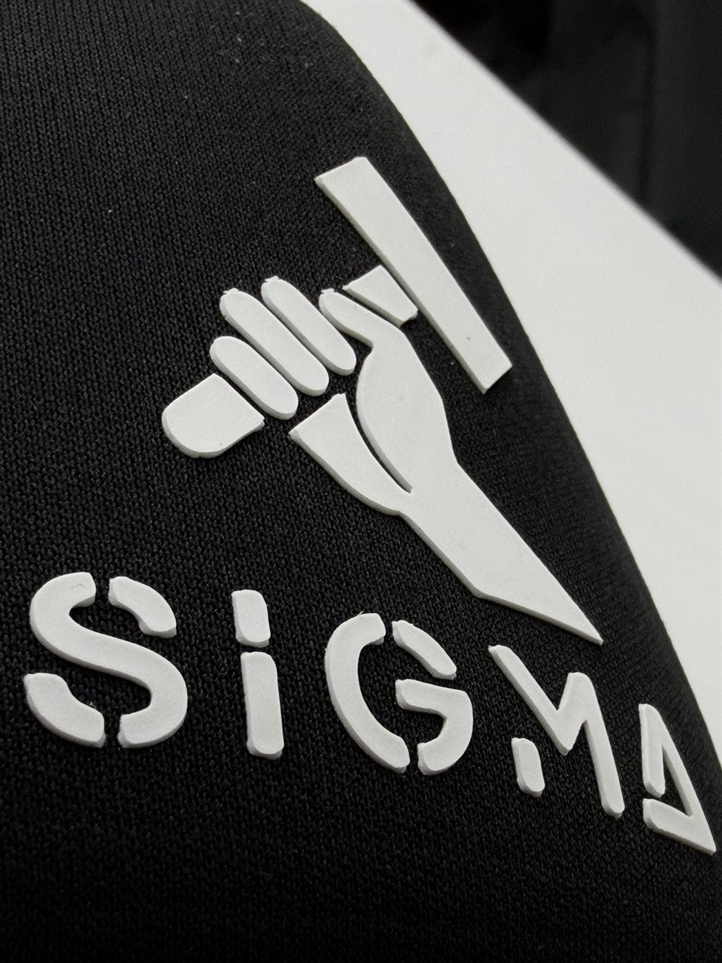 Raised 3D puff vinyl logo on black — sharp edges, real texture