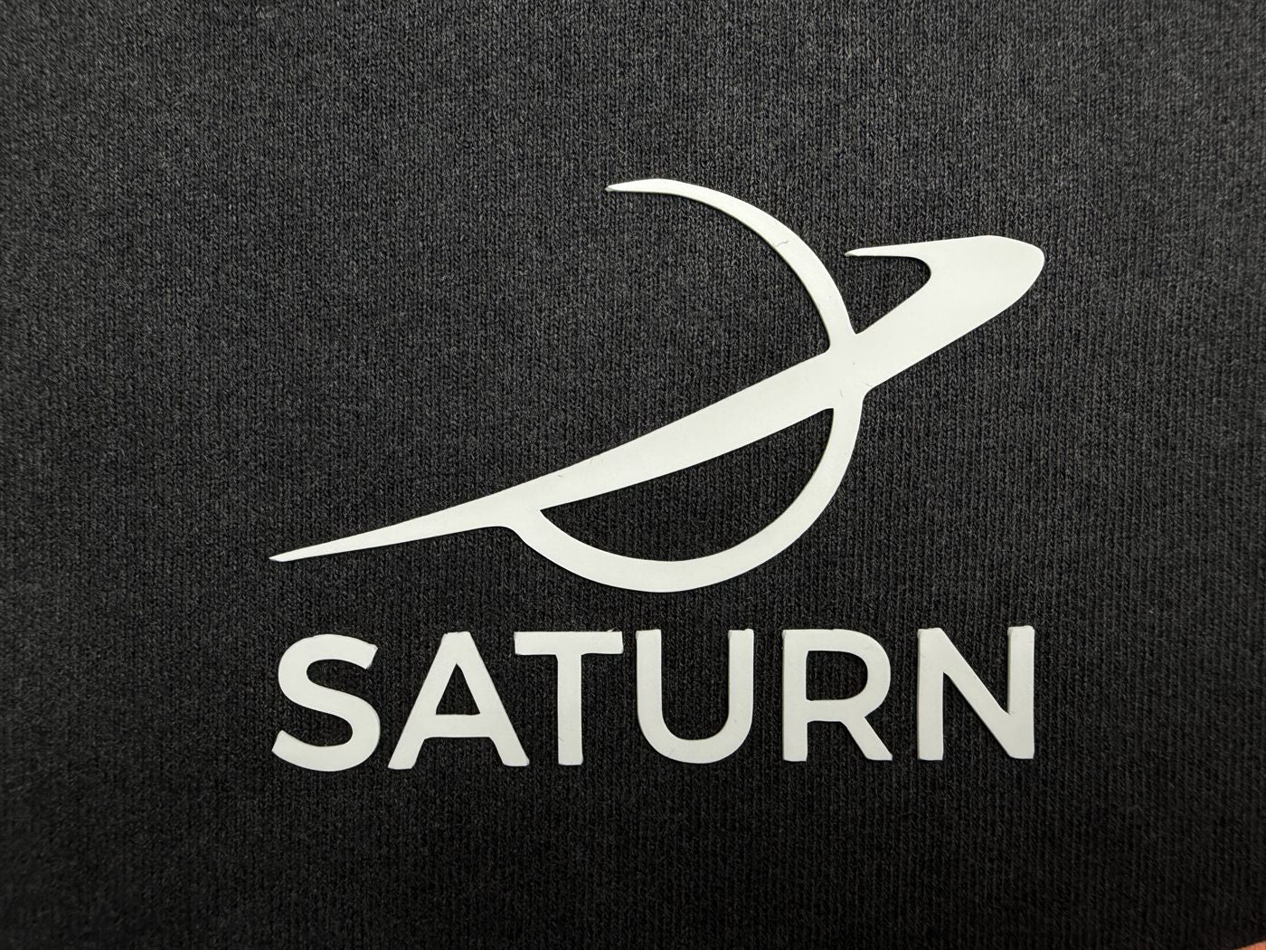Clean one-color vinyl logo on dark heather